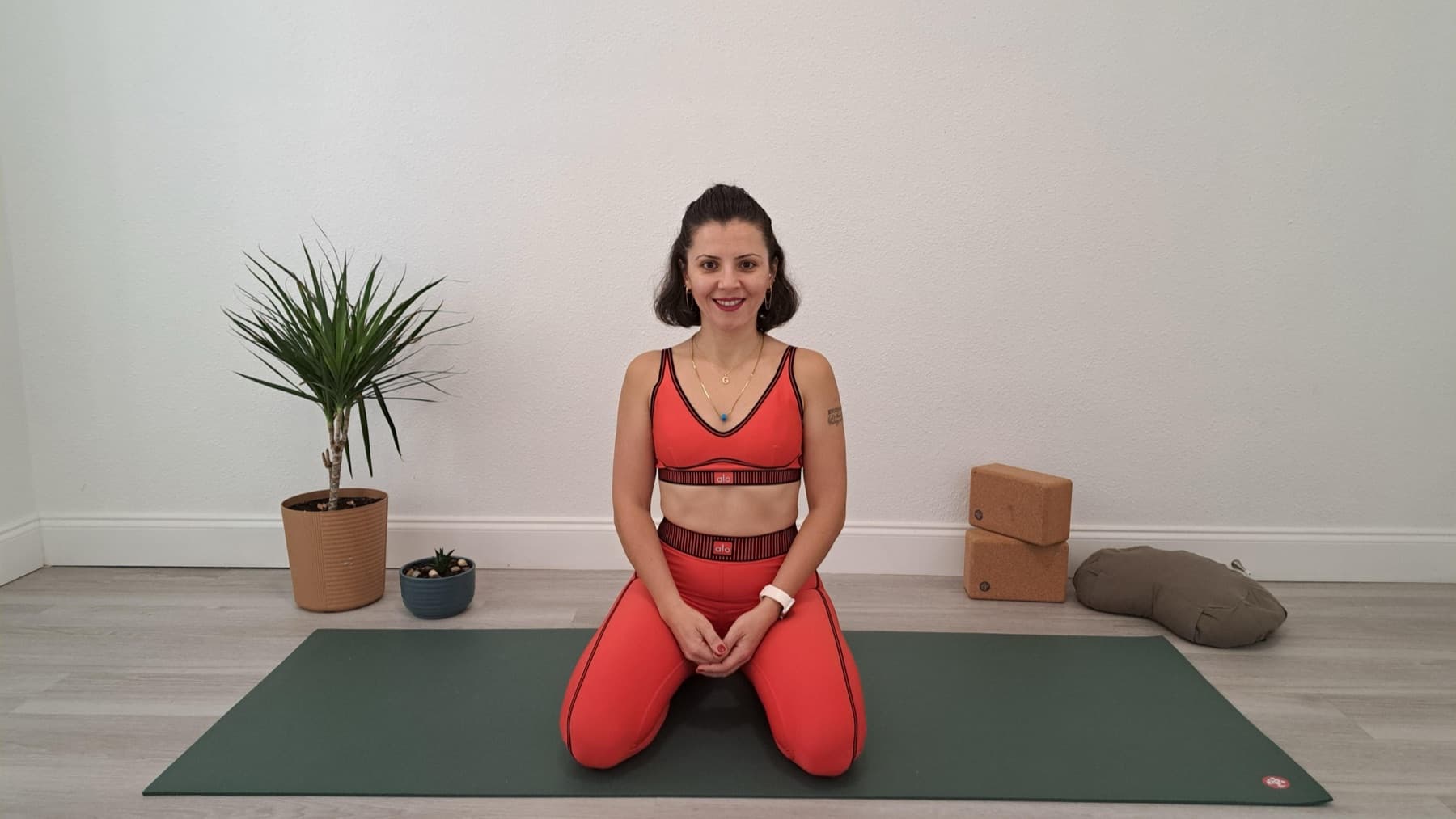 Gülçin in her studio with cork blocks and a plant